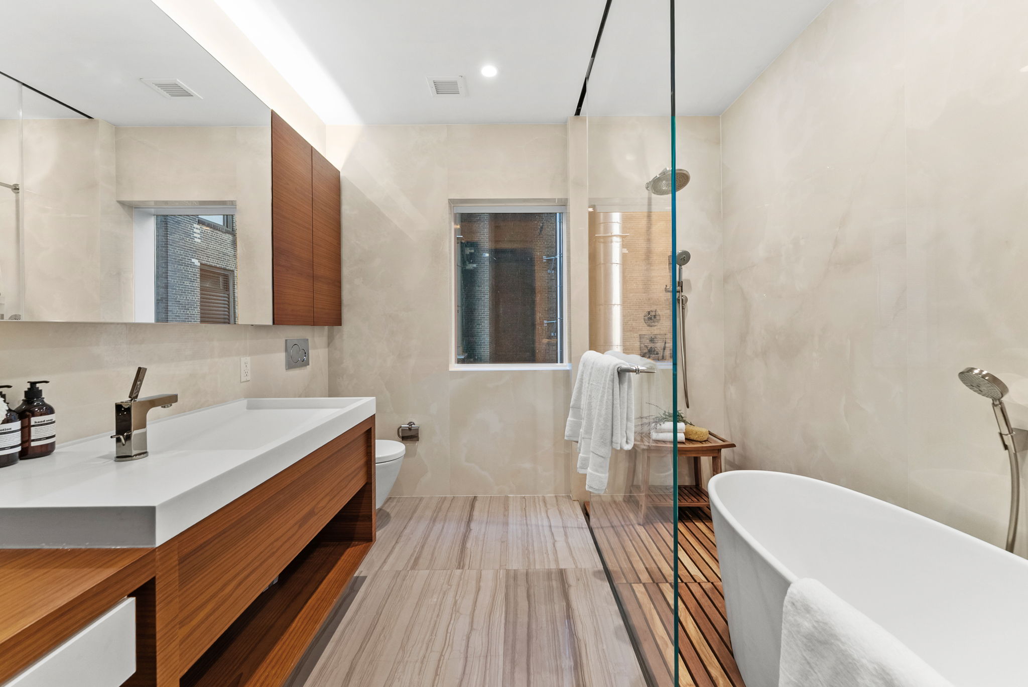 19 Park Place, Unit 14A Manhattan, NY 10007 - Photo 11 of 19 a bathroom with a sink a bathtub and a shower