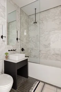 a bathroom with a sink toilet and shower