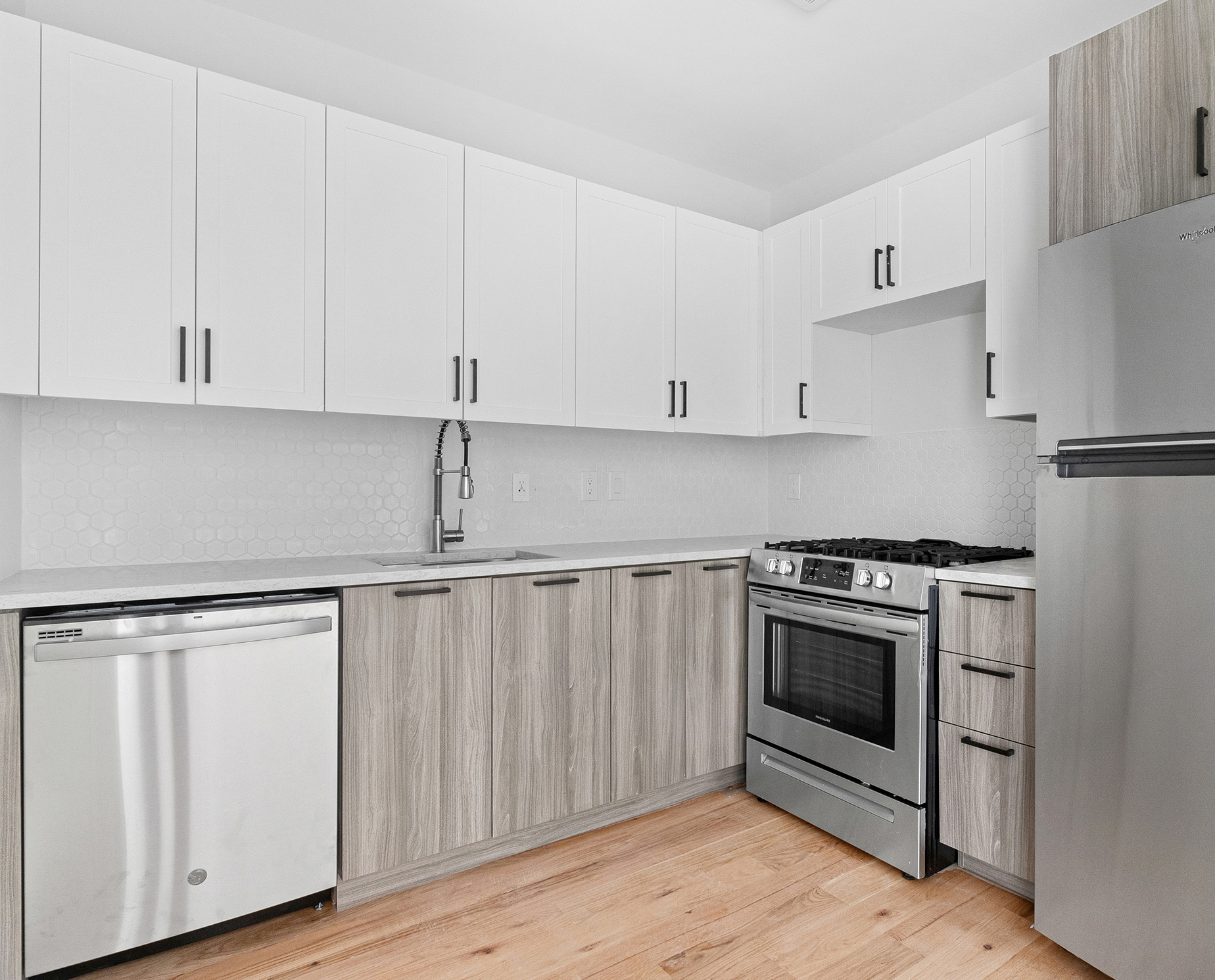 1098 Madison Street, Unit 4B Brooklyn, NY 11221 - Photo 5 of 11 a kitchen with white cabinets and white appliances