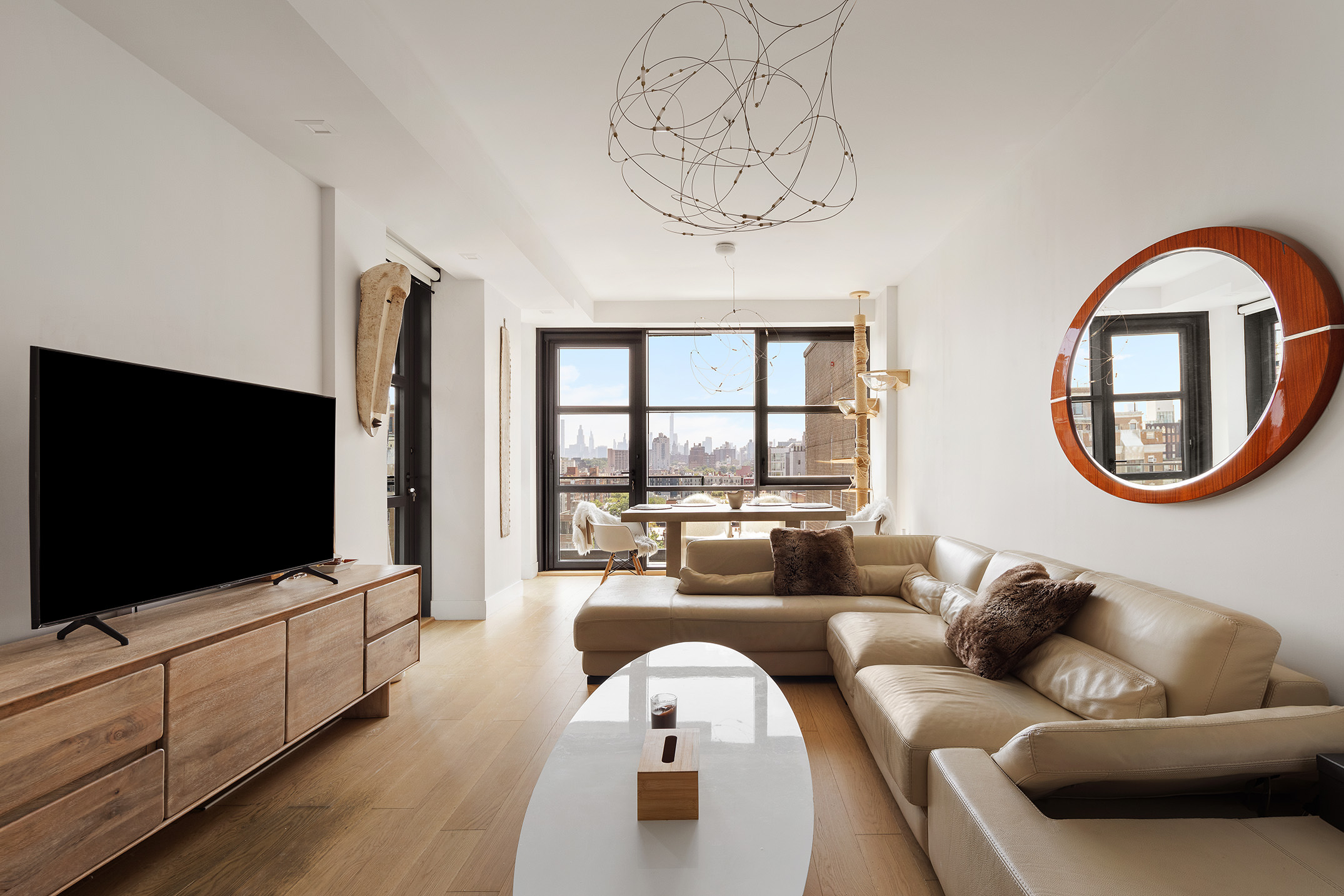 11 Hancock Place, Unit PH102 Manhattan, NY 10027 - Photo 2 of 18 a living room with furniture and a flat screen tv