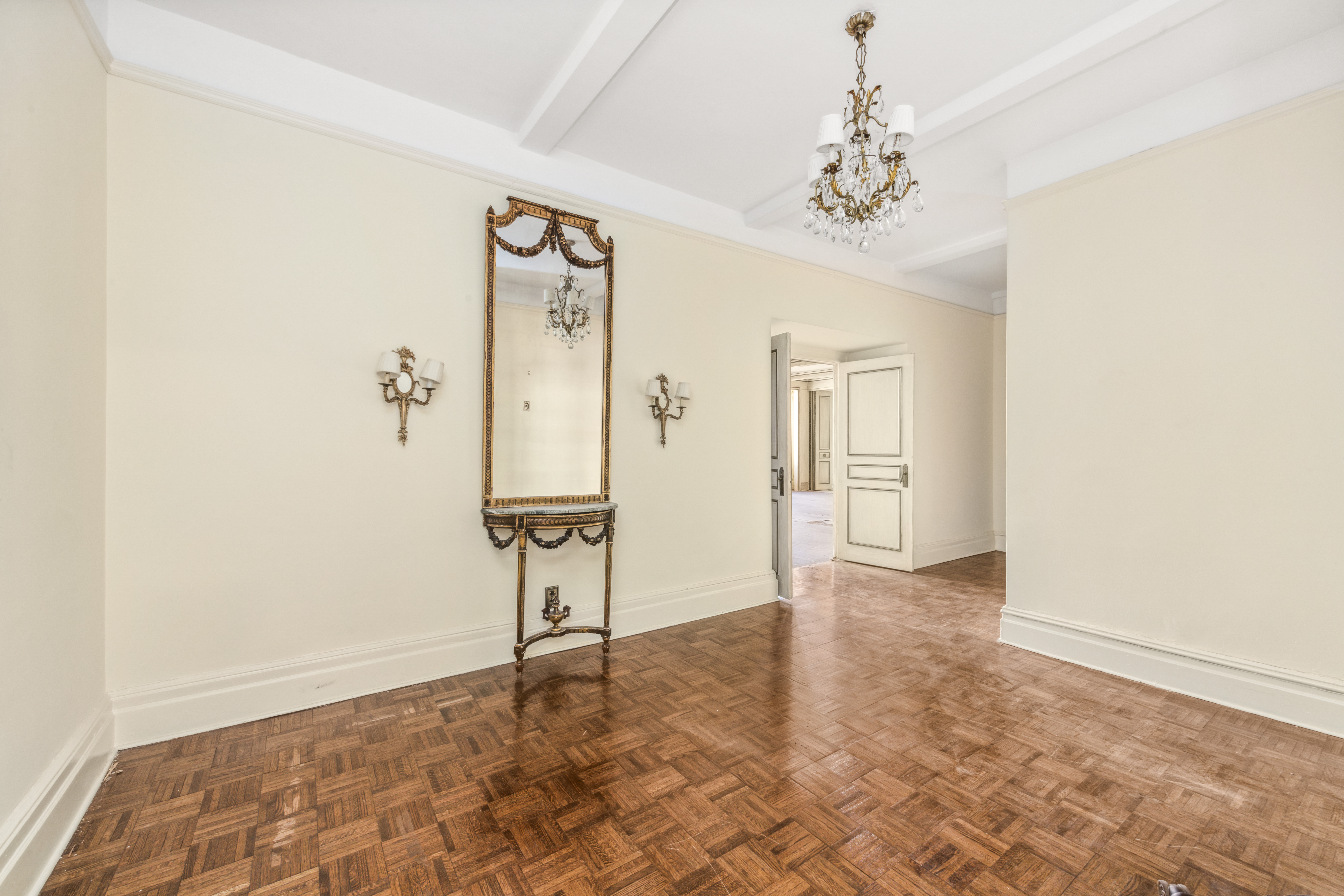 130 East 67th Street, Unit 9C Manhattan, NY 10065 - Photo 11 of 20 a view of a hallway with a chandelier