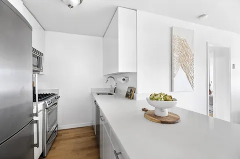 a kitchen with a sink and a stove