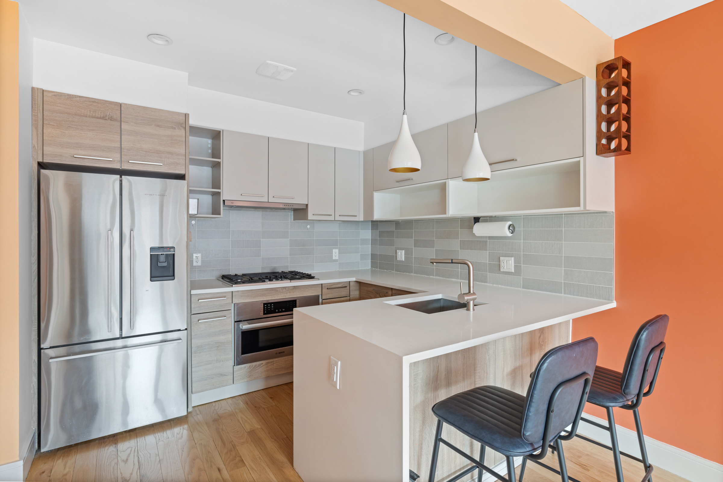 479 Monroe Street, Unit 2F Brooklyn, NY 11221 - Photo 1 of 6 a kitchen with stainless steel appliances a stove a sink a refrigerator and chairs