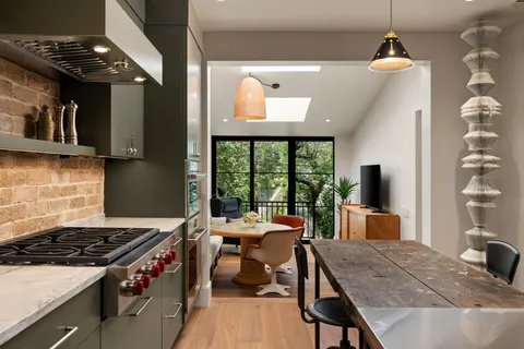 a living room with furniture a window and kitchen view