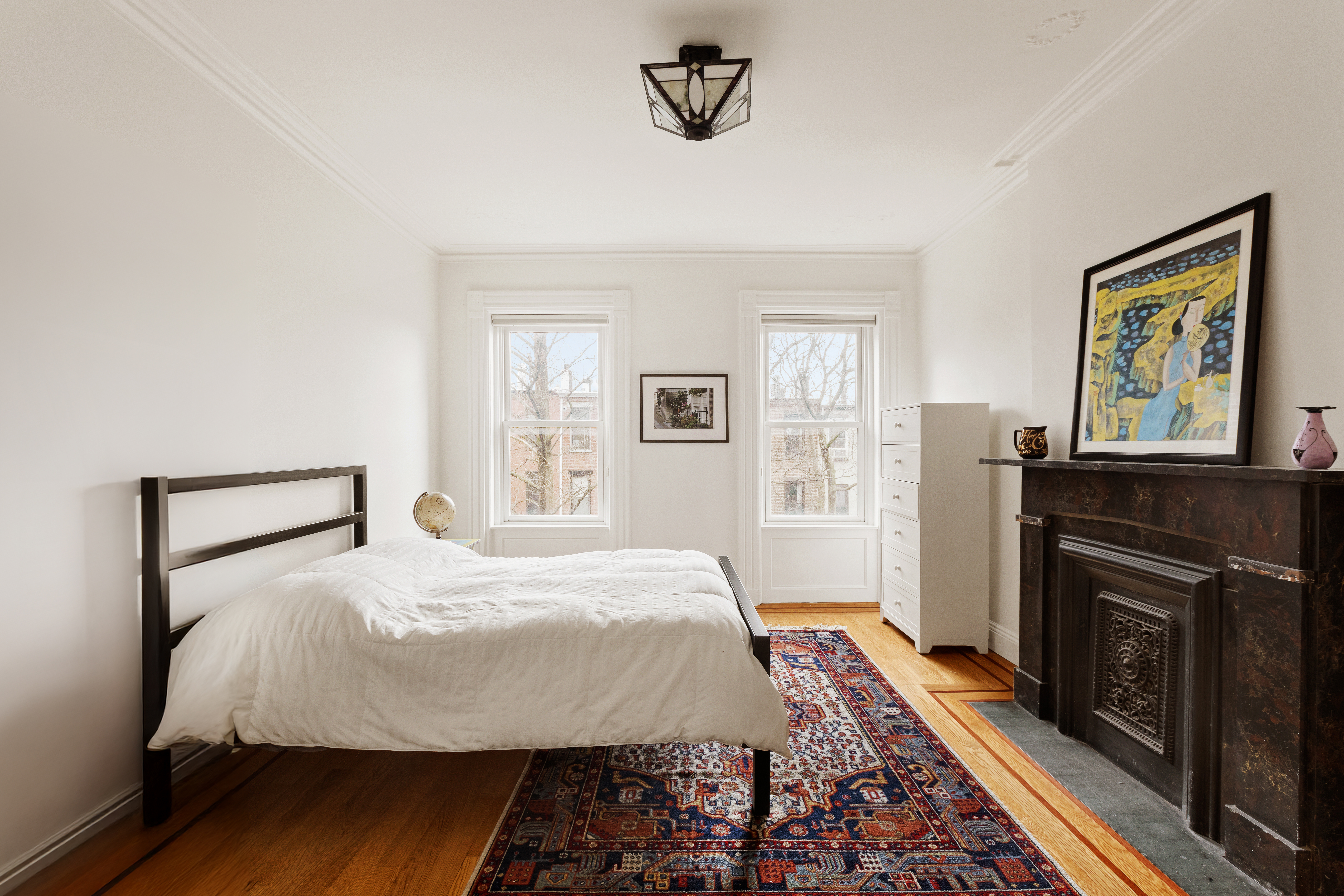 196 Berkeley Place Brooklyn, NY 11217 - Photo 18 of 25 a bedroom with a bed and a fireplace