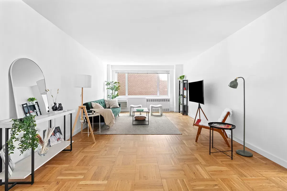 a living room with furniture a flat screen tv and a floor to ceiling window