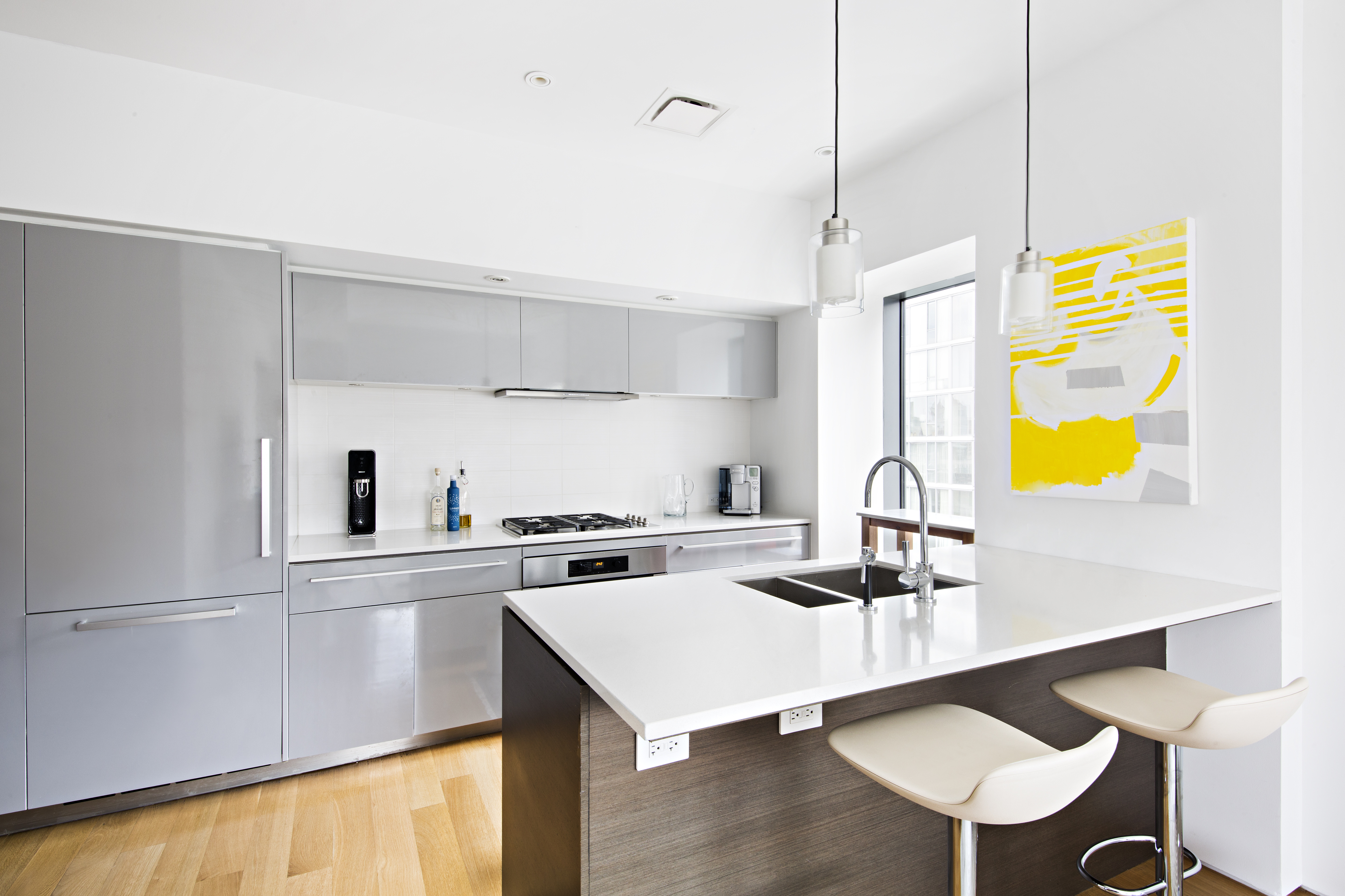 123 3rd Avenue, Unit 11A Manhattan, NY 10003 - Photo 3 of 11 a kitchen with a sink a stove and chairs