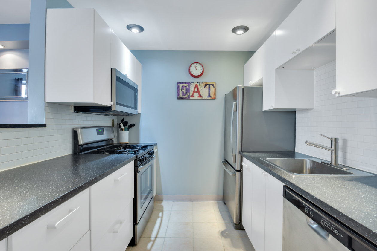 1787 Madison Avenue, Unit 312 Manhattan, NY 10035 - Photo 3 of 8 a kitchen with stainless steel appliances granite countertop a sink stove and refrigerator