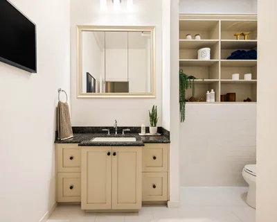 a bathroom with a granite countertop sink and a mirror