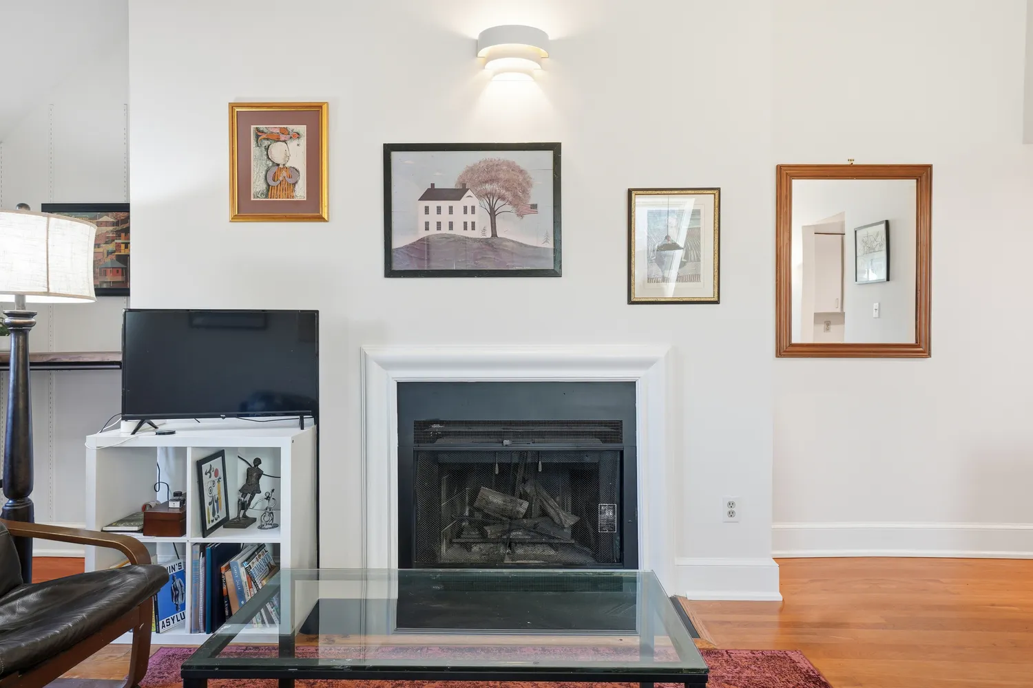 a living room with furniture a fireplace and a flat screen tv
