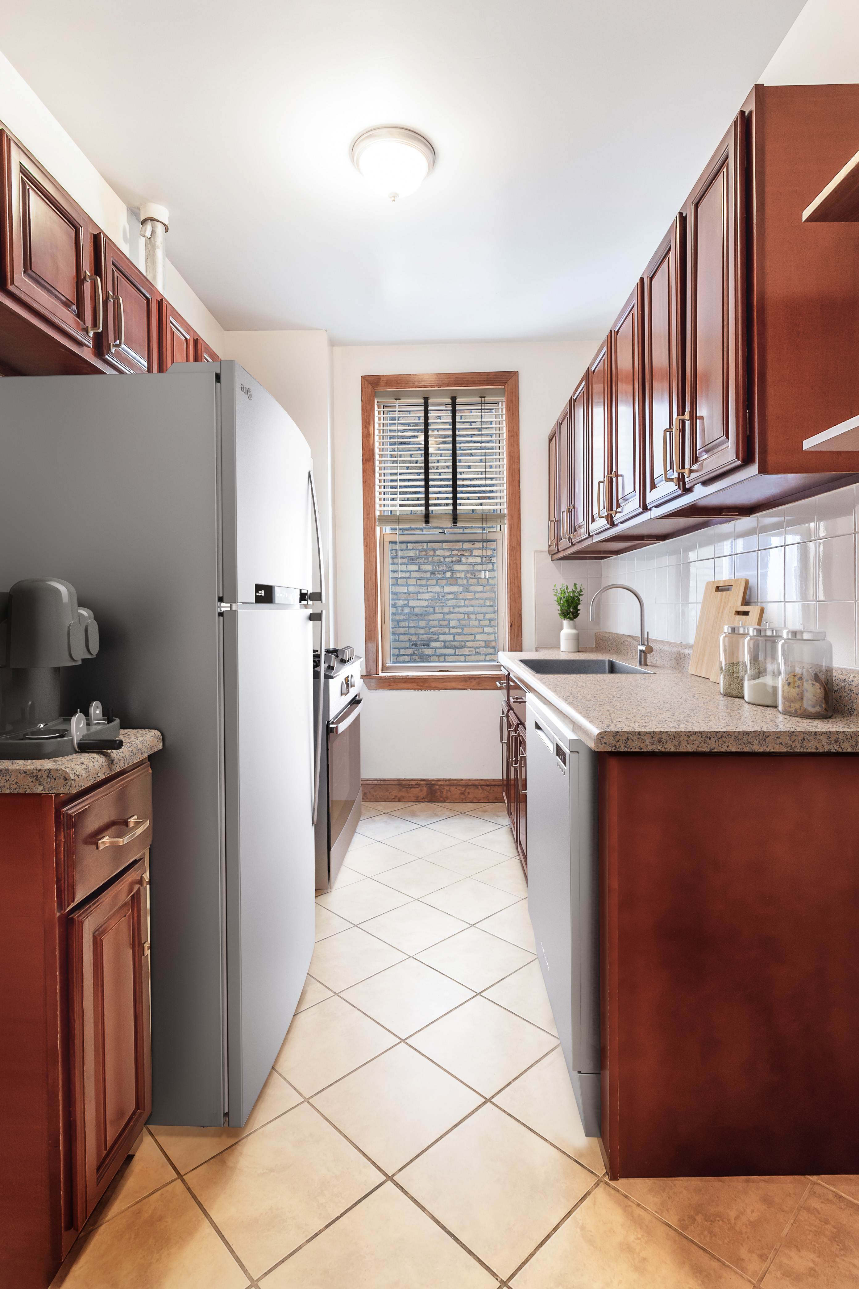 200 West 93rd Street, Unit 2E Manhattan, NY 10025 - Photo 3 of 6 a kitchen with stainless steel appliances granite countertop a refrigerator and a stove top oven
