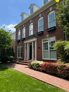 front view of a brick house with a yard