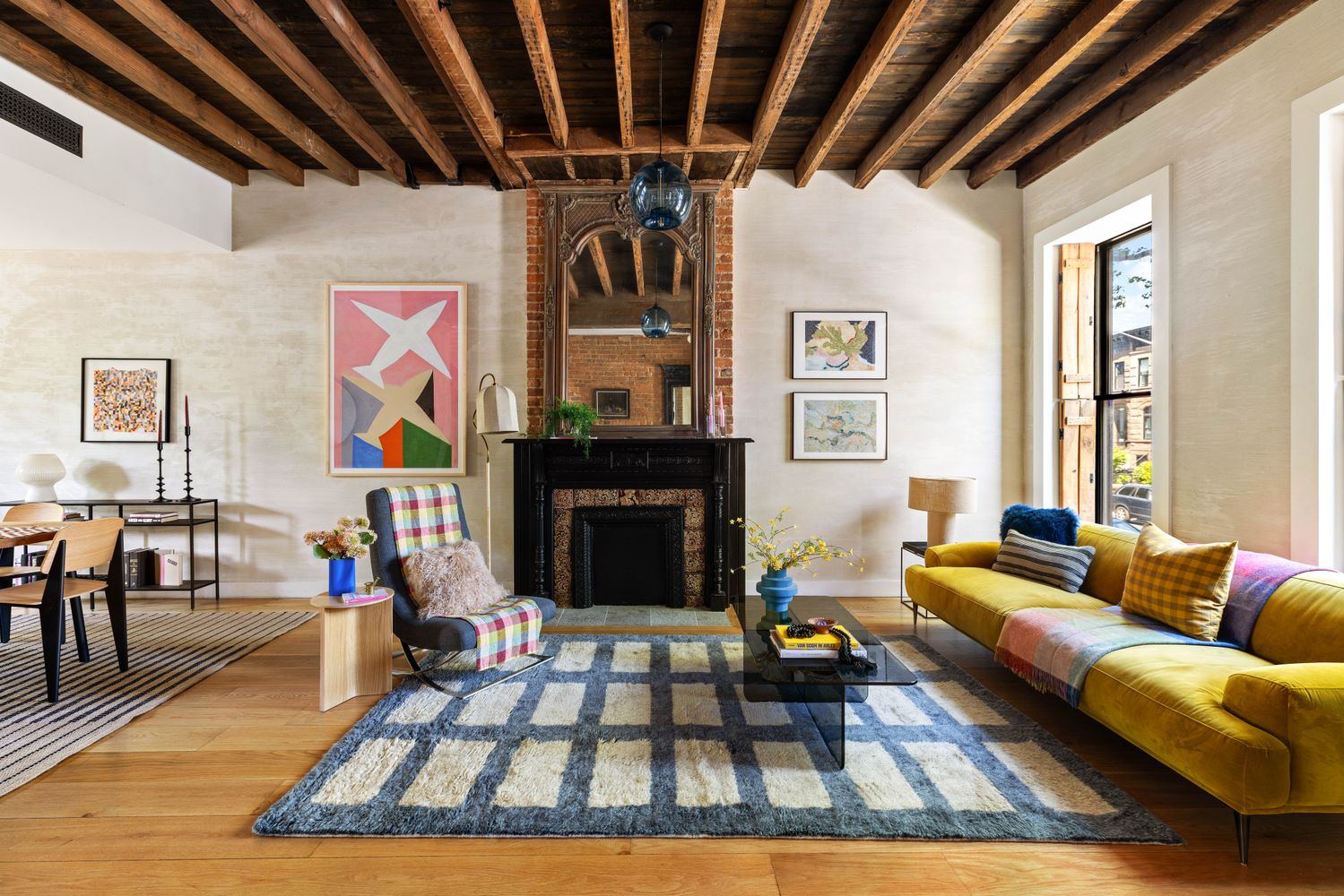 a living room with furniture a rug and a fireplace