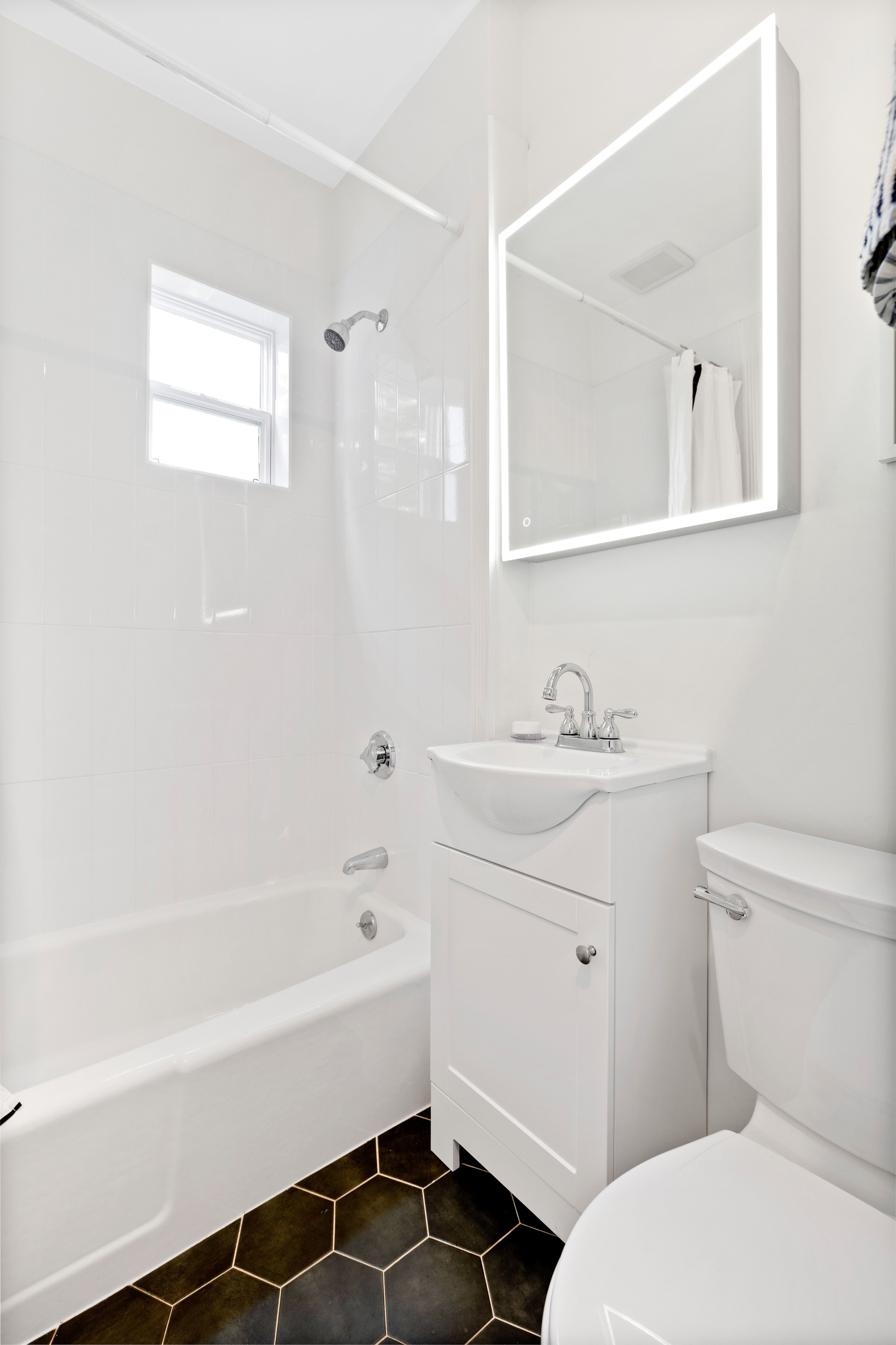 90 Maple Place Dedham, MA 02026 - Photo 25 of 40 a bathroom with a sink a toilet and shower