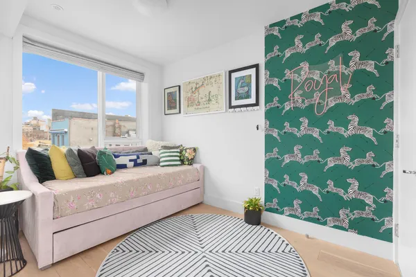 a living room with a couch and a potted plant