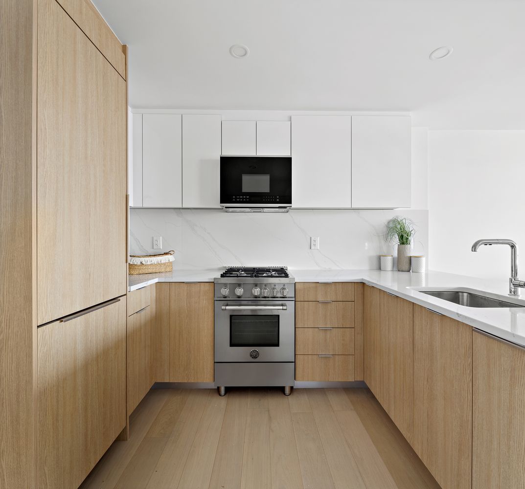 a kitchen with a sink and a stove top oven