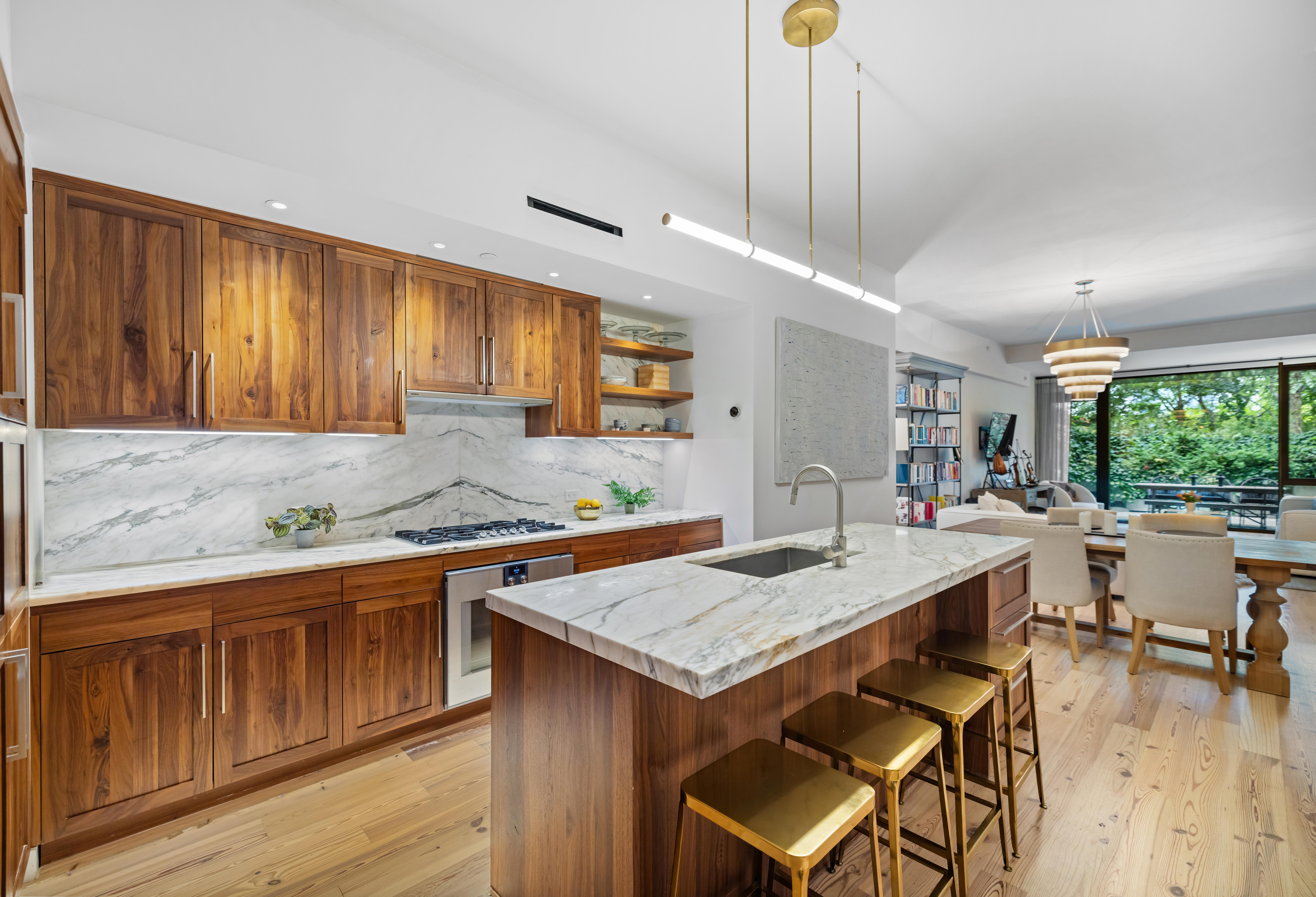 130 Furman Street, Unit S102 Brooklyn, NY 11201 - Photo 4 of 26 a kitchen with a stove a refrigerator a sink dishwasher with a dining table and chairs with wooden floor