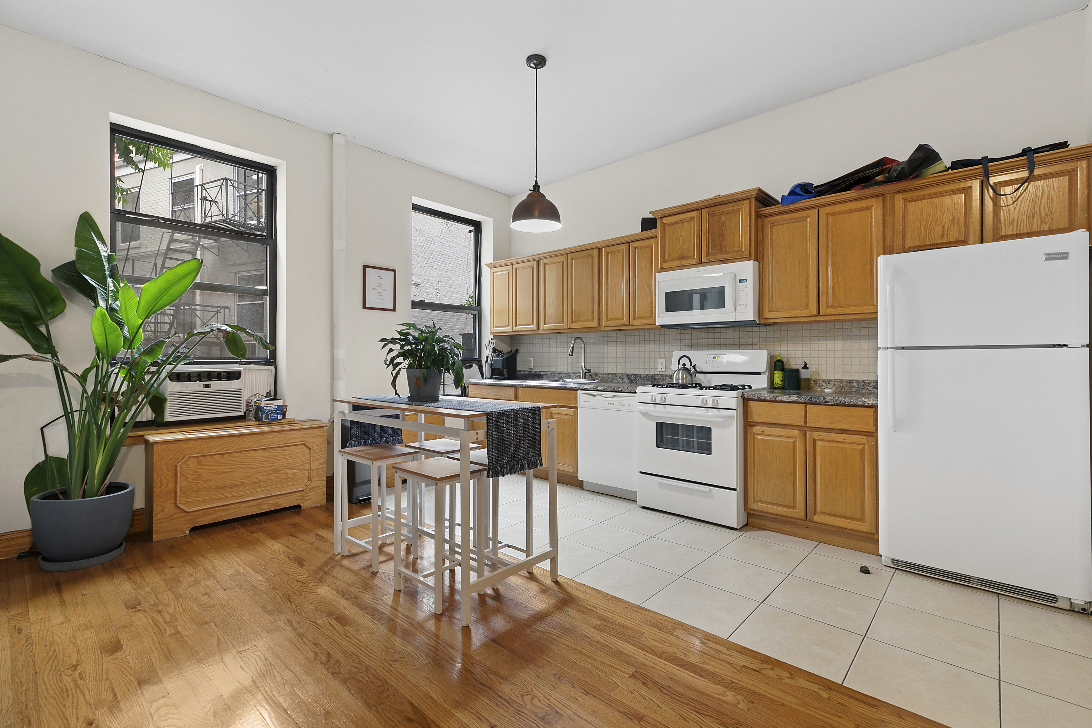 548 1/2 Hudson Street, Unit 2 Manhattan, NY 10014 - Photo 1 of 6 a kitchen with a refrigerator and a stove top oven
