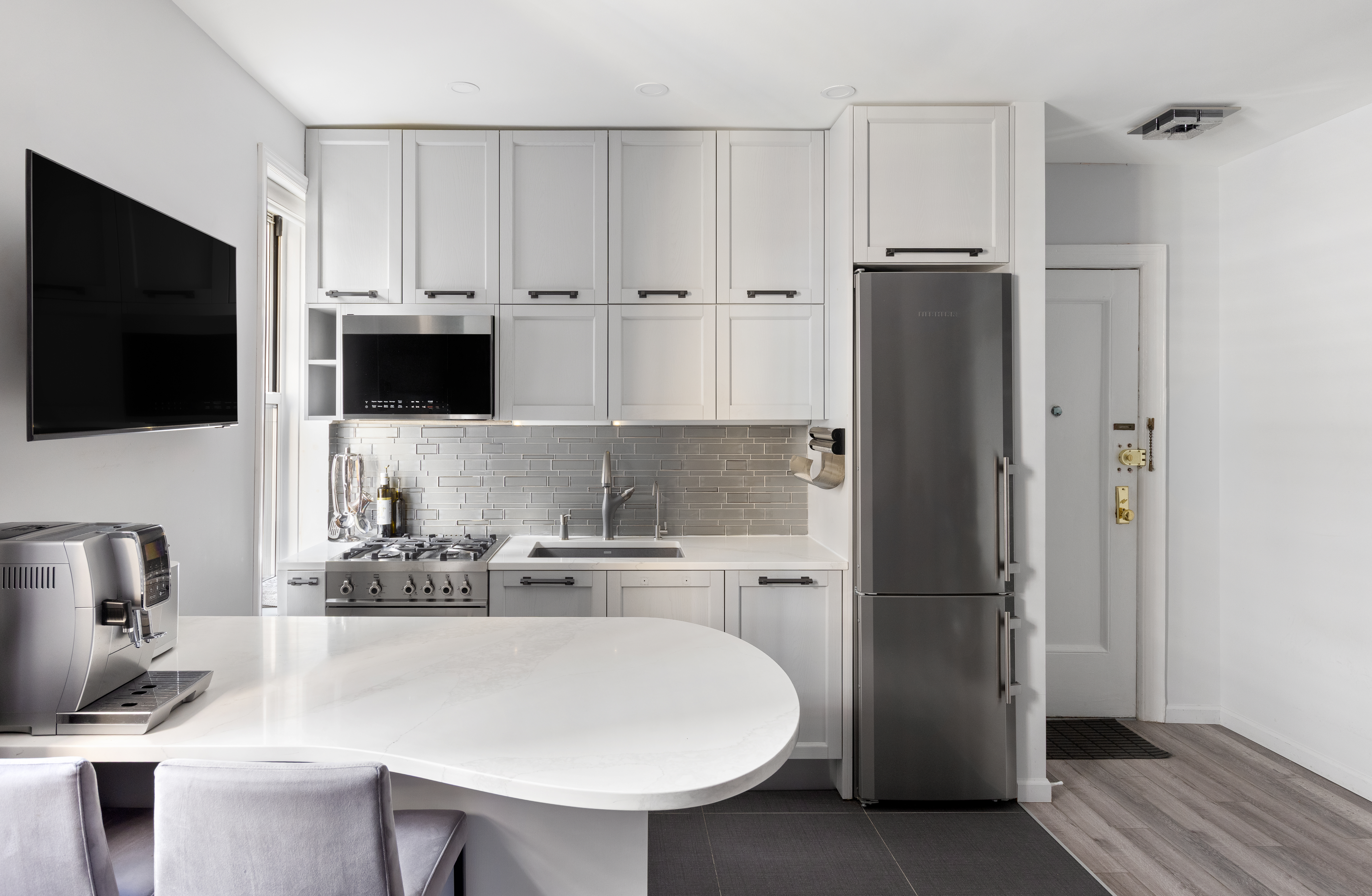 59 Pineapple Street, Unit 3F Brooklyn, NY 11201 - Photo 1 of 8 a kitchen with stainless steel appliances a refrigerator stove and microwave