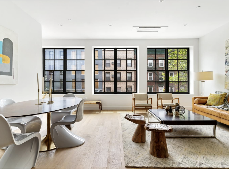 a living room with furniture and large window