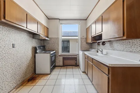 a kitchen with stainless steel appliances granite countertop a sink stove and cabinets