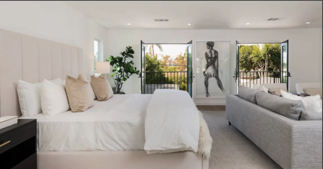 a spacious bedroom with a large bed and a large window