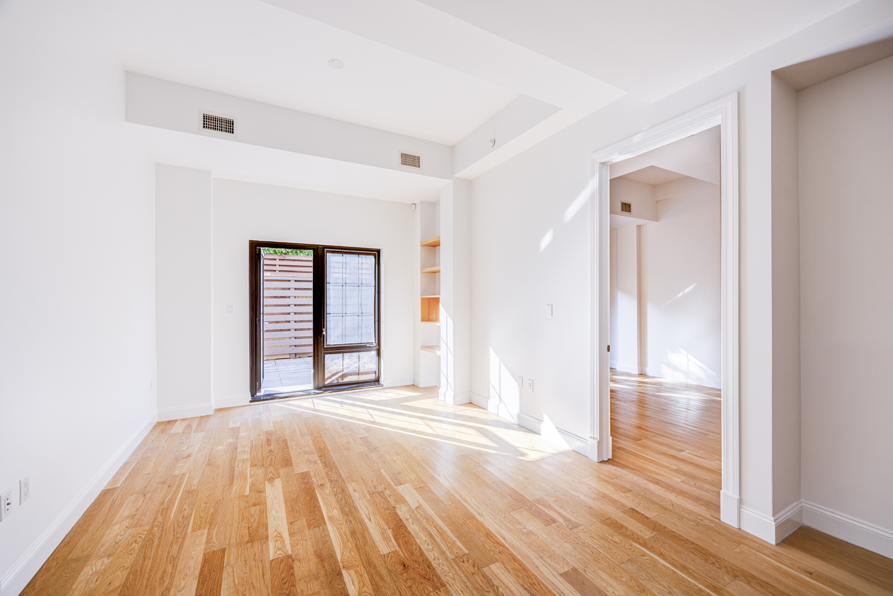 42 Maspeth Avenue, Unit 1D Brooklyn, NY 11211 - Photo 12 of 28 a view of a room with wooden floor and door
