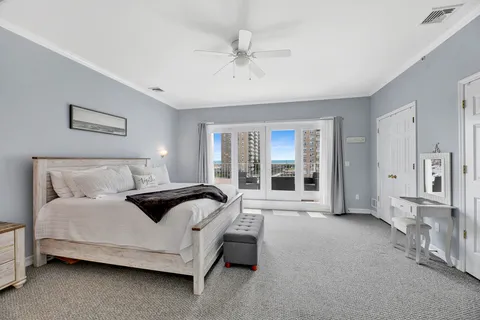 a spacious bedroom with a bed and glass door