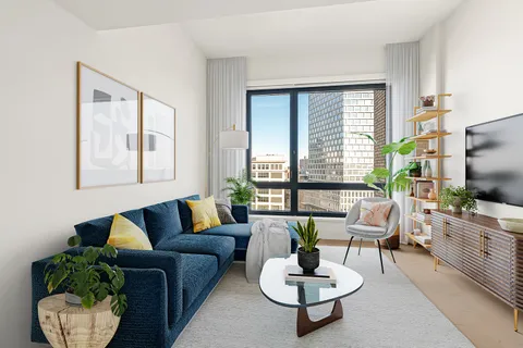 a living room with furniture a flat screen tv and a large window