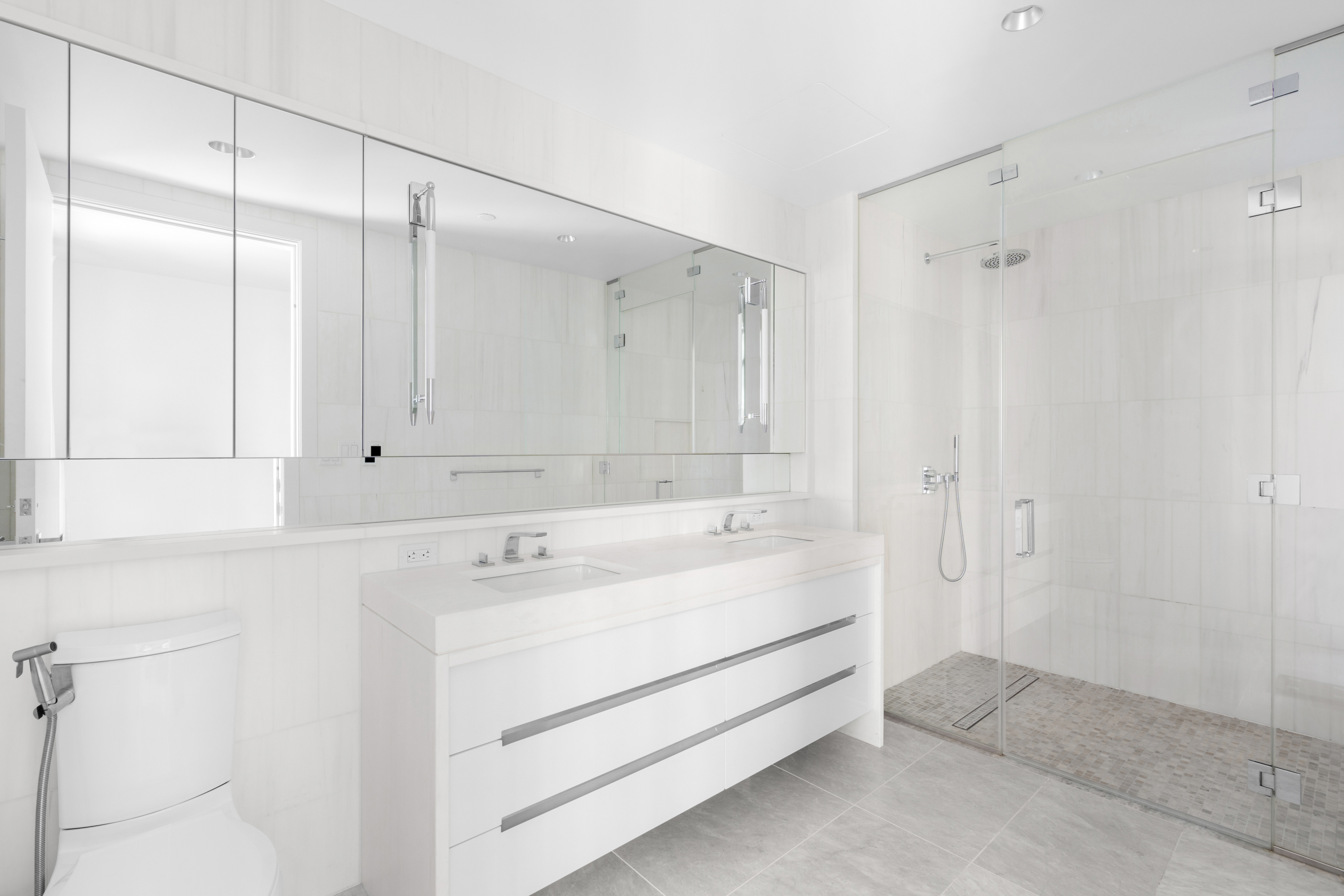 212 West 95th Street, Unit 4A Manhattan, NY 10025 - Photo 6 of 13 a view of bathroom with a sink mirror and shower