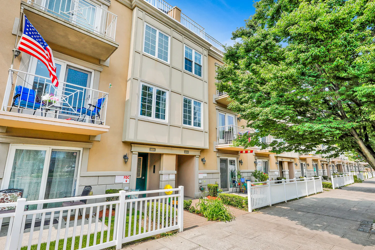 a front view of a building with a garden