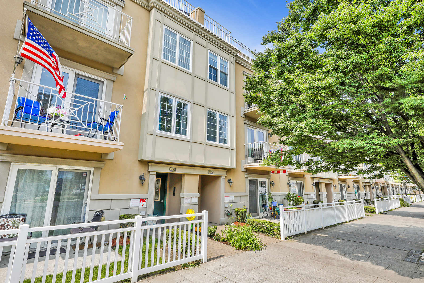 102-20 Rockaway Beach Boulevard, Unit 3C Queens, NY 11694 - Photo 3 of 36 a front view of a building with a garden