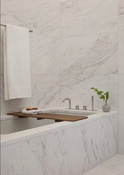 611 West 56th Street, Unit 6D Manhattan, NY 10019 - Photo 3 of 10 a bathroom with a granite countertop sink and a bathtub