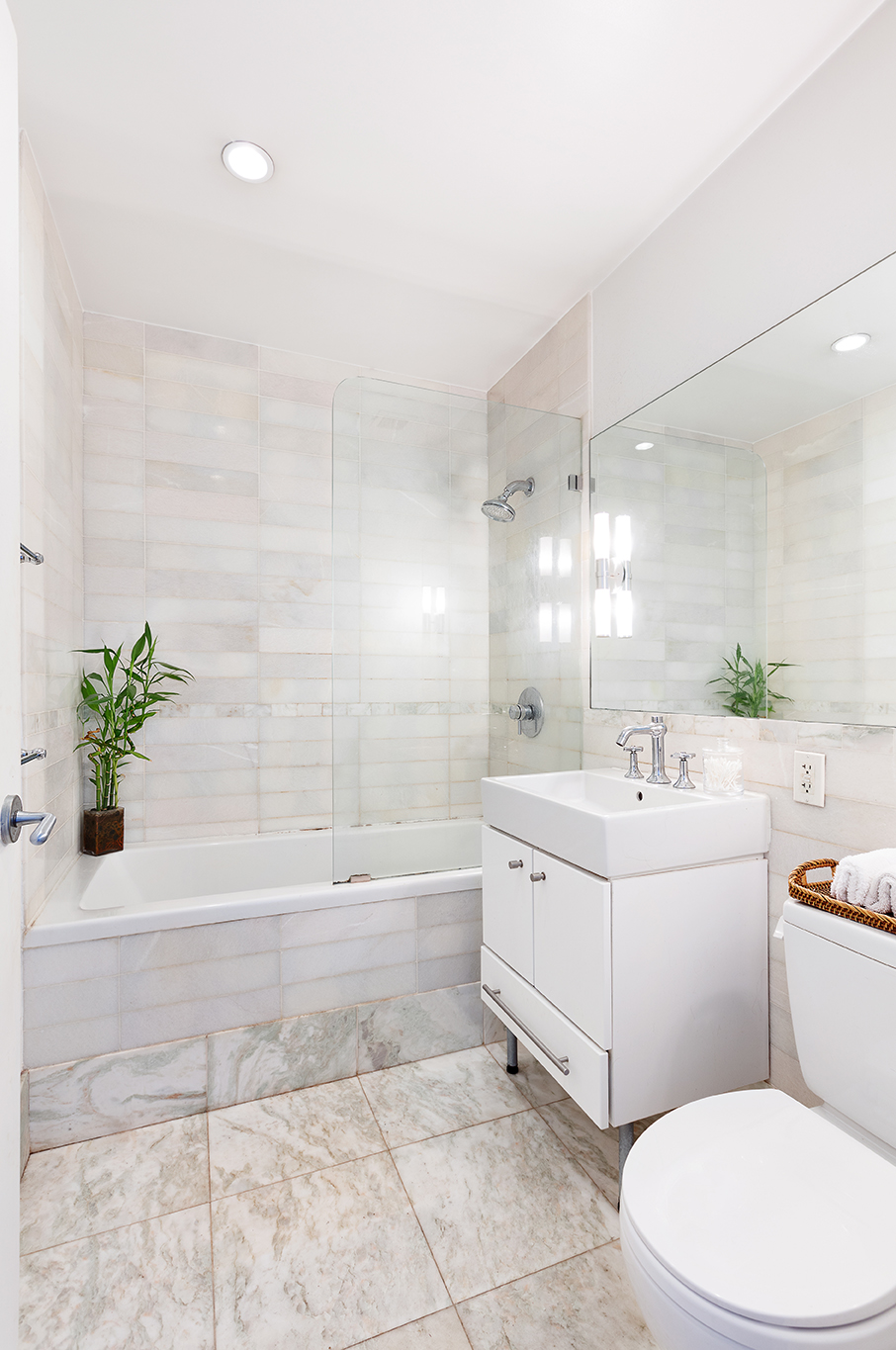 635 West 42nd Street, Unit 17D Manhattan, NY 10036 - Photo 4 of 6 a bathroom with a sink a toilet and bathtub