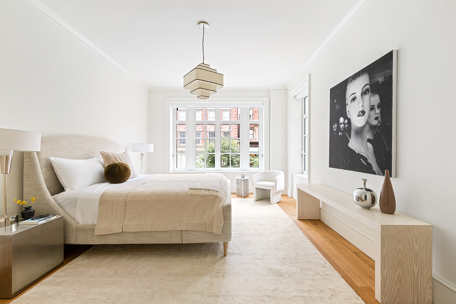 1045 Madison Avenue, Unit 3B Manhattan, NY 10075 - Photo 7 of 14 a bedroom with a bed and a chandelier