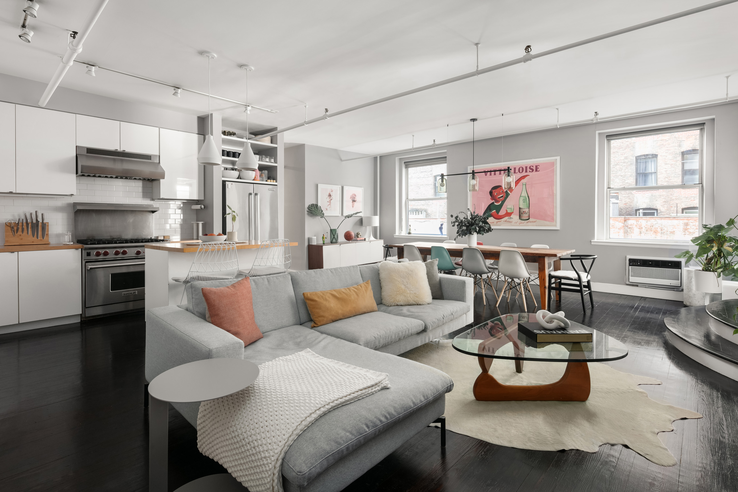 133-131 West 28th Street, Unit 6C Manhattan, NY 10001 - Photo 1 of 10 a living room with stainless steel appliances furniture and a kitchen view
