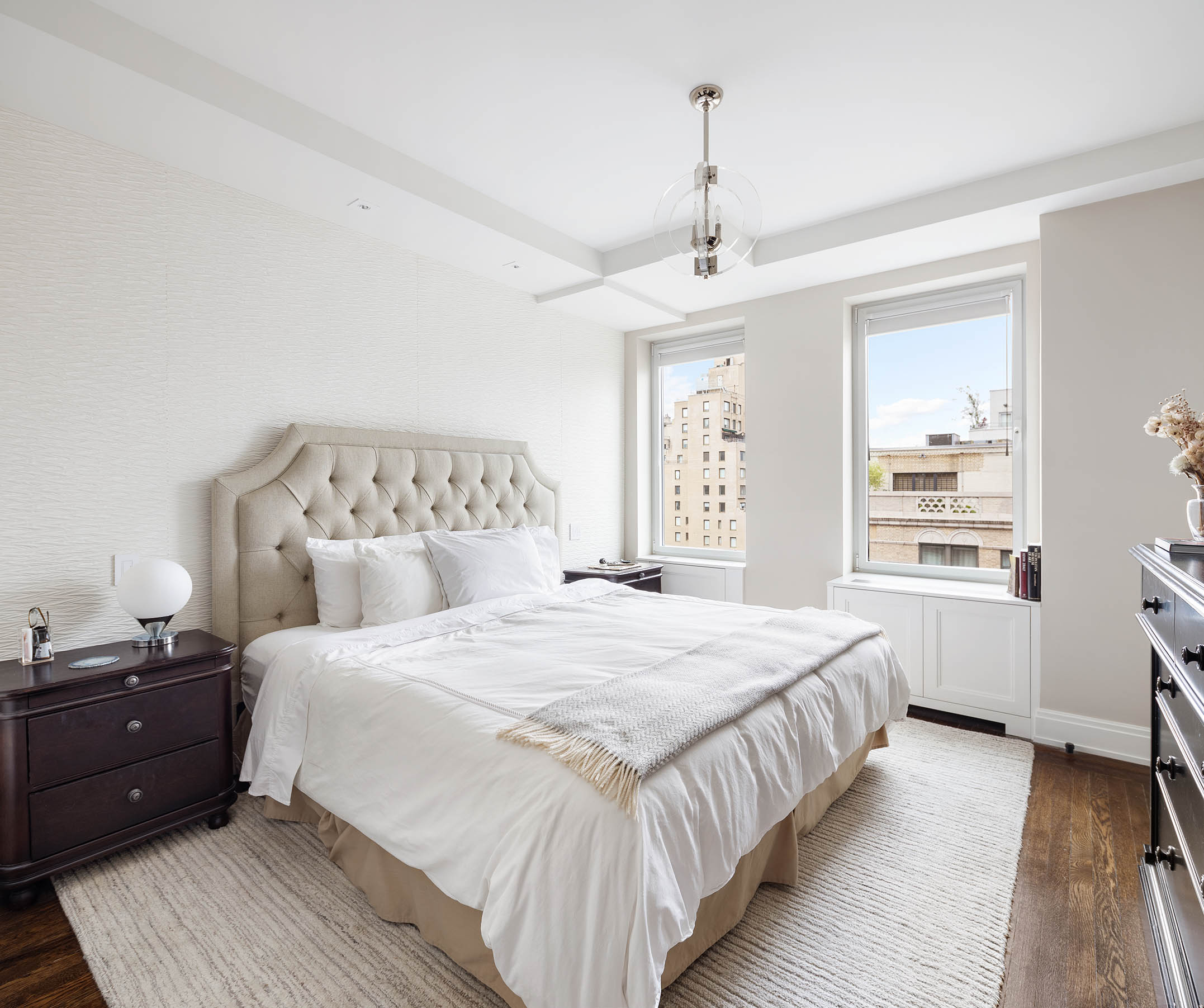49 East 86th Street, Unit 17B Manhattan, NY 10028 - Photo 5 of 11 a bedroom with a bed and wooden floor