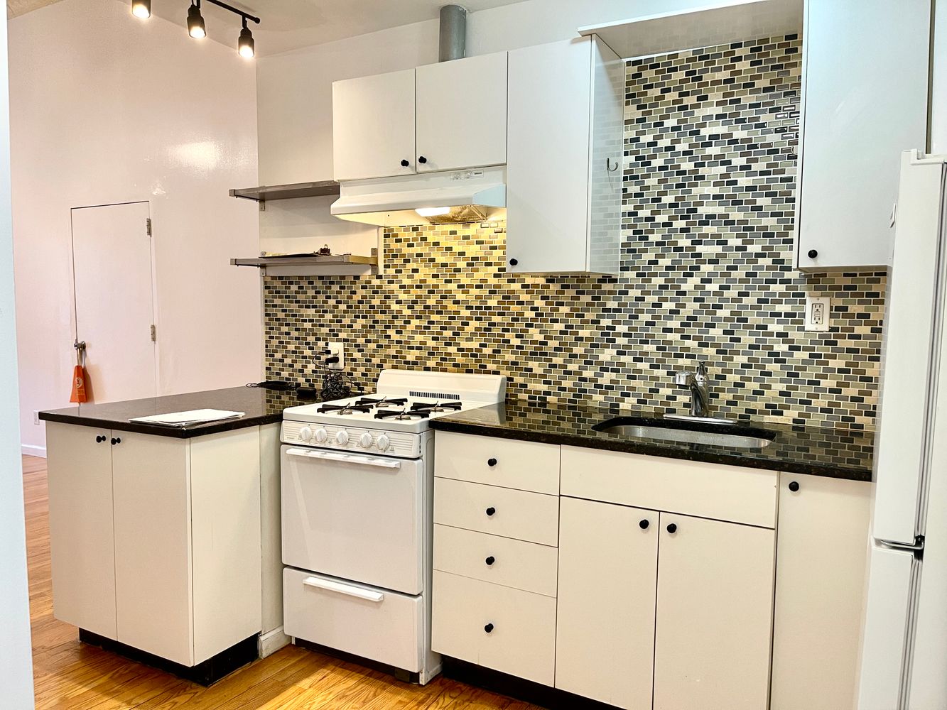 1672 Park Avenue Manhattan, NY 10035 - Photo 13 of 35 a kitchen with white cabinets and white appliances