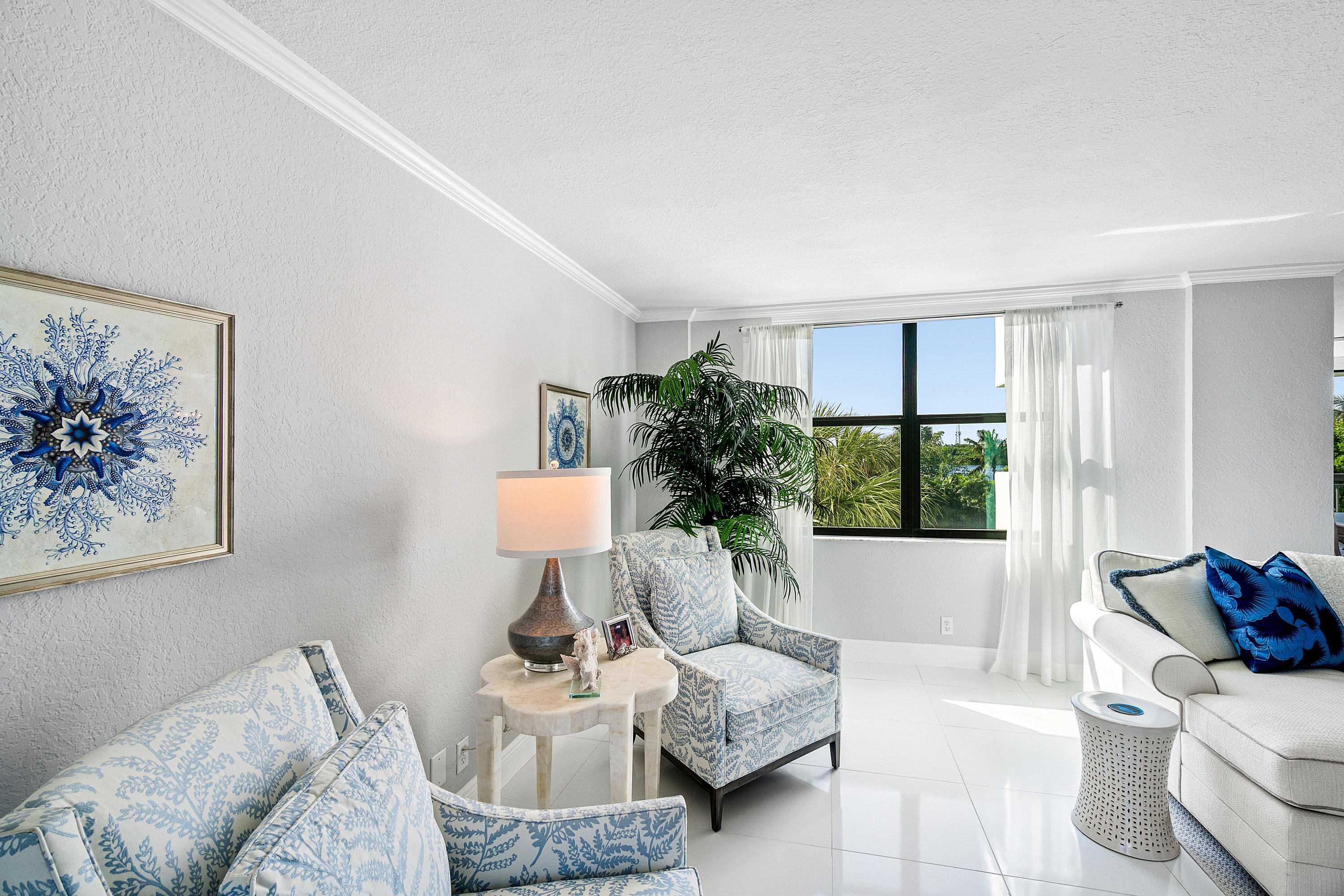 2003 North Ocean Boulevard, Unit 305 Boca Raton, FL 33431 - Photo 9 of 56 a living room with furniture and a large window