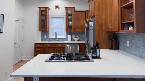 a white stove top oven sitting inside of a kitchen