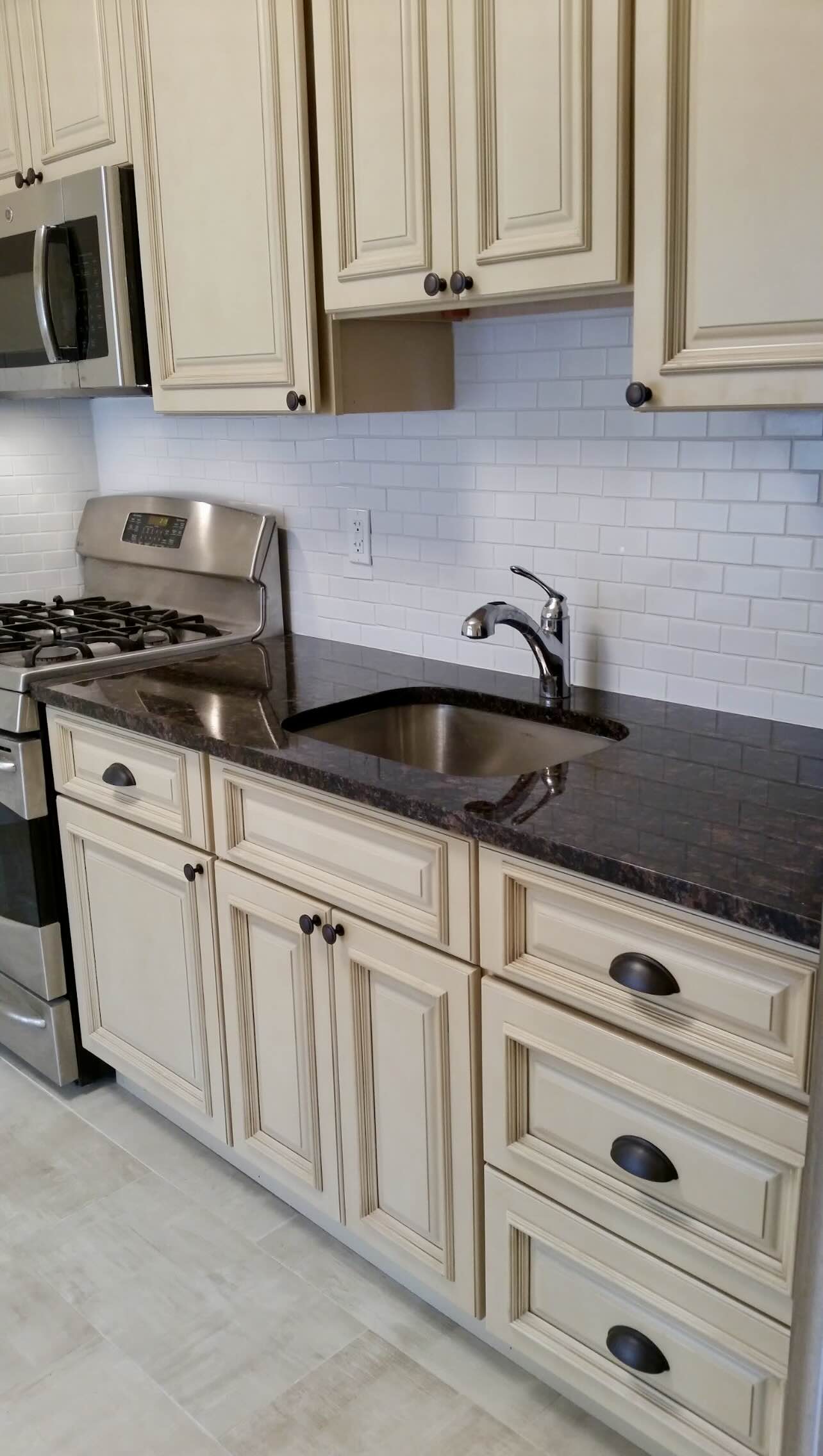 3194 Webster Avenue Bronx, NY 10467 - Photo 12 of 23 a kitchen with white cabinets and white appliances