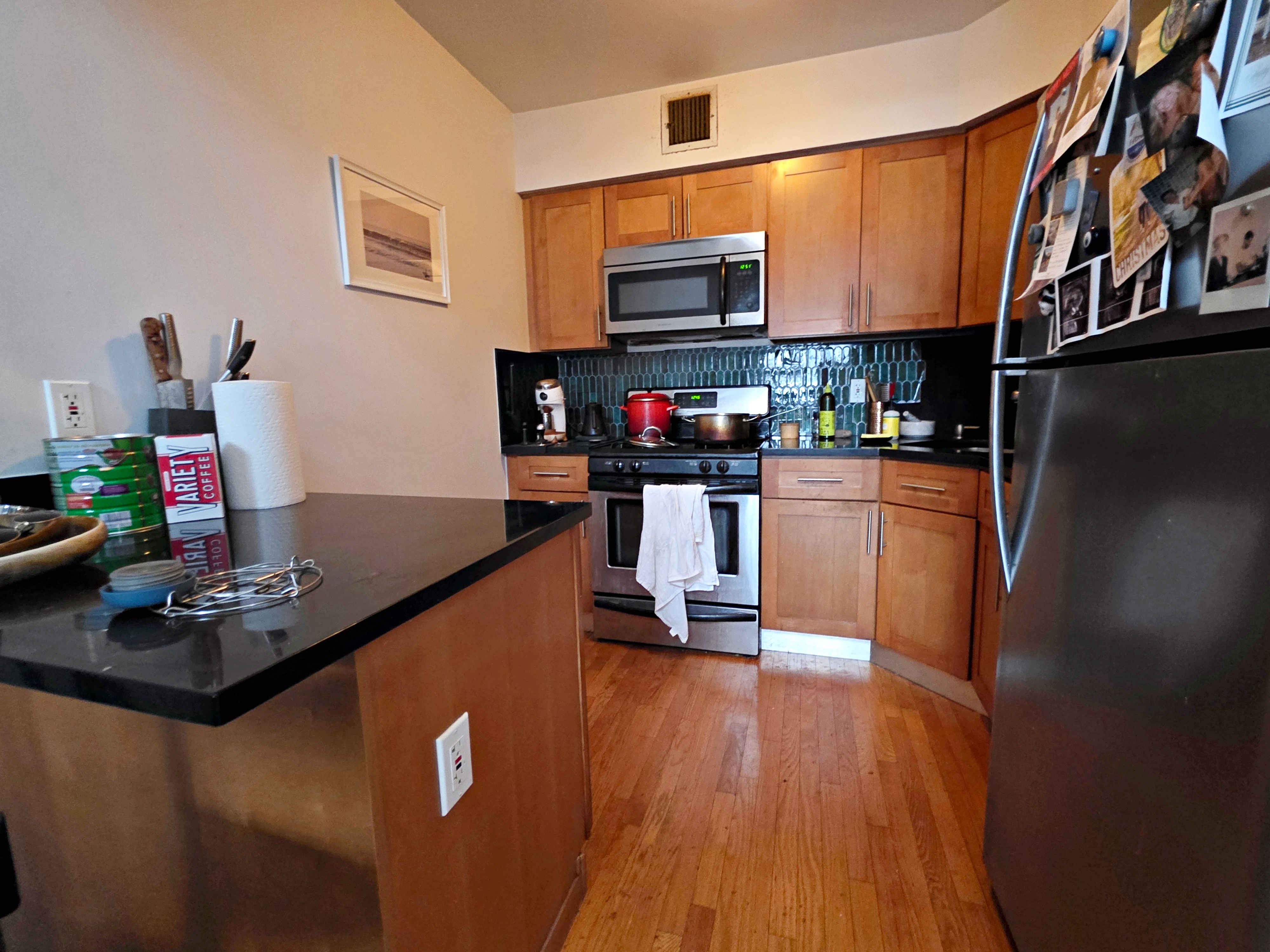 713 Metropolitan Avenue, Unit 4R Brooklyn, NY 11211 - Photo 6 of 11 a kitchen with stainless steel appliances a stove refrigerator sink and microwave
