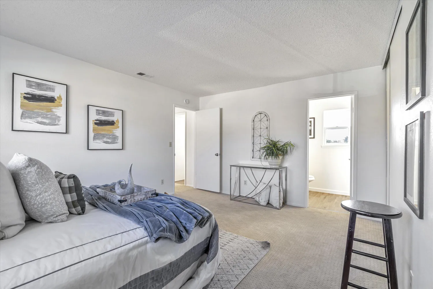 a large bed sitting in a bedroom next to a window