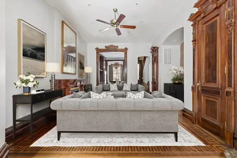 a living room with a couch and a chandelier