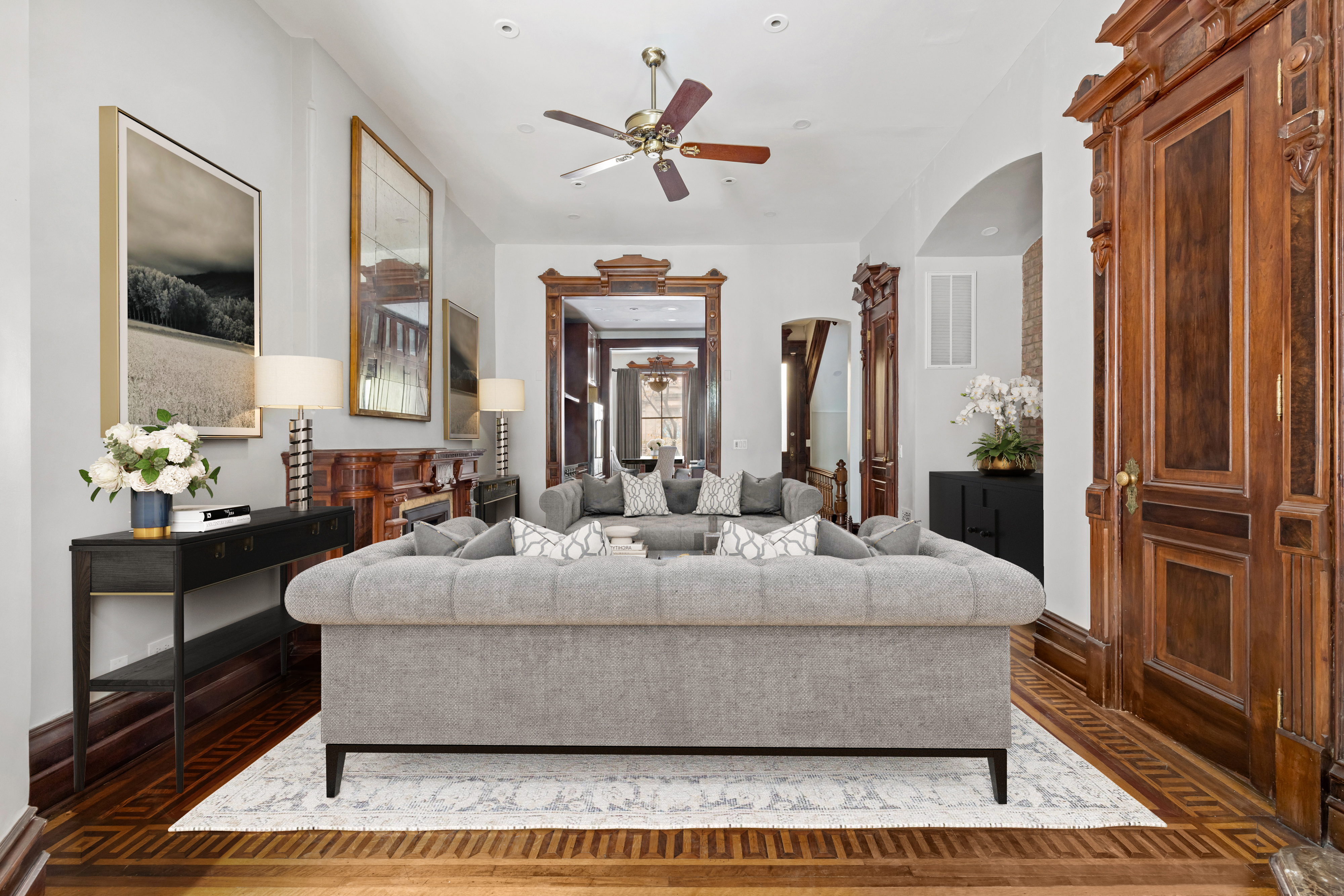 29 East 126th Street, Unit A Manhattan, NY 10035 - Photo 2 of 13 a living room with a couch and a chandelier