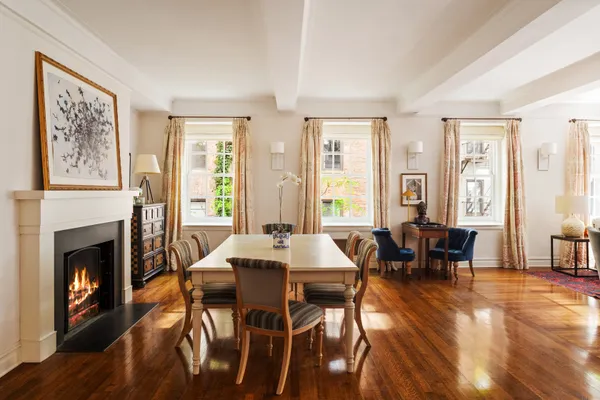 a view of a a dining room with furniture window and wooden floor