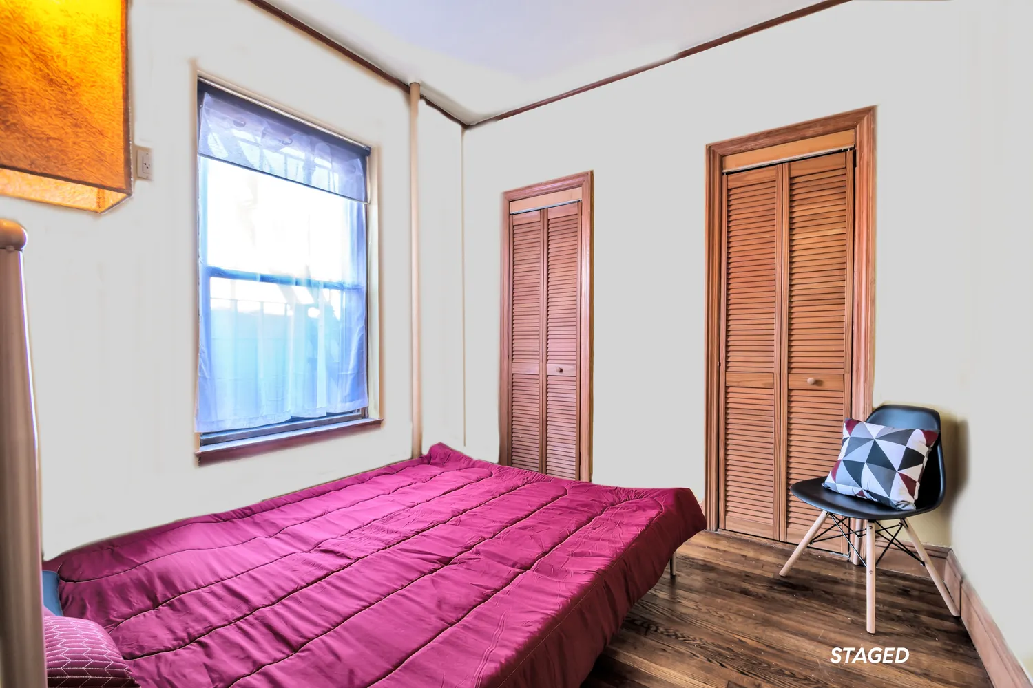 a bedroom with a bed and a window