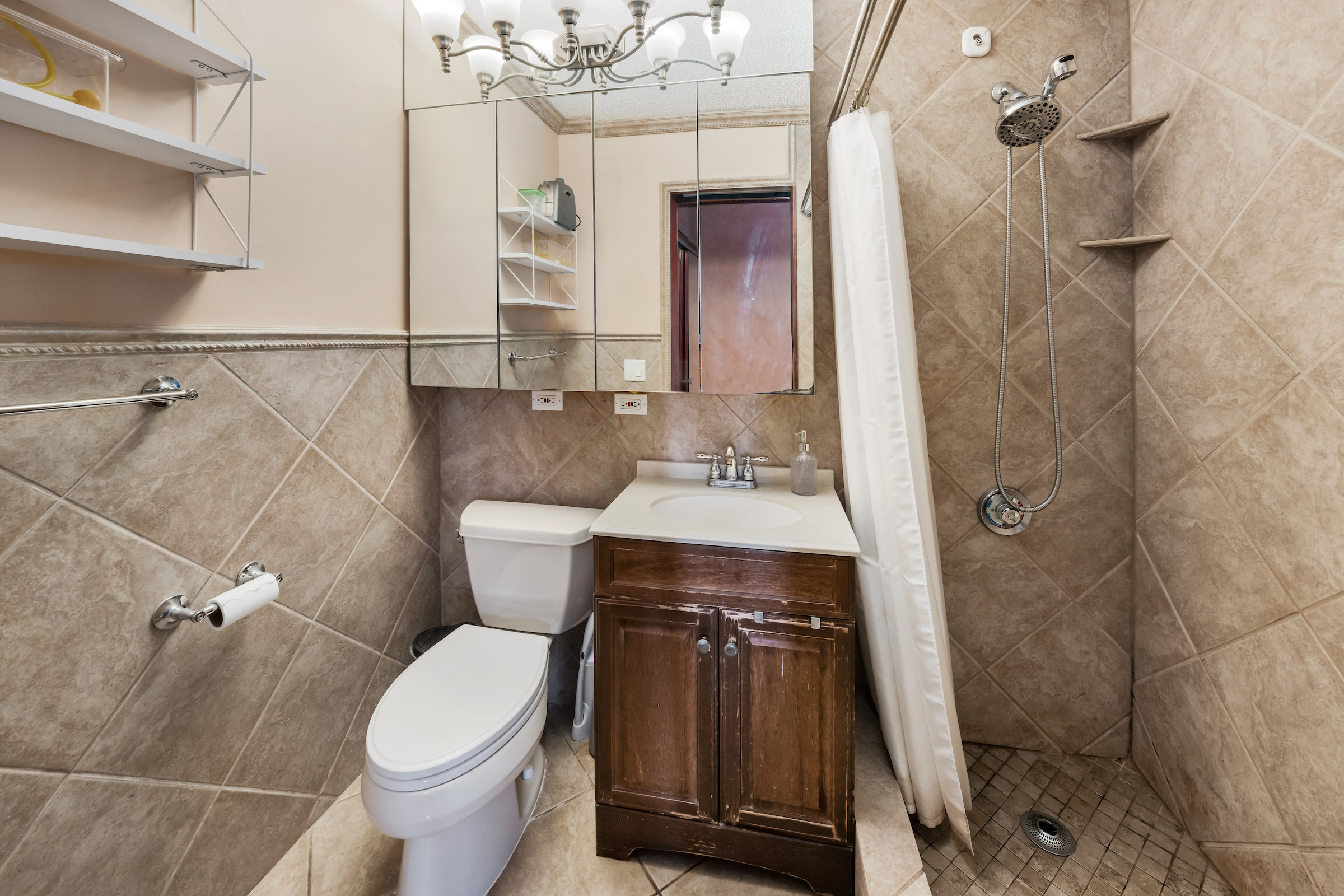 4-74 48th Avenue, Unit 27A Queens, NY 11109 - Photo 13 of 17 a bathroom with a sink a toilet and shower