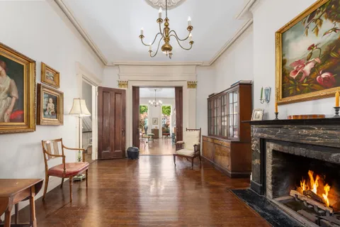 a living room with furniture a fireplace and wooden floor