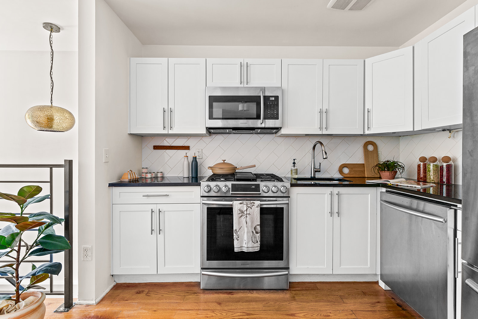120 Pulaski Street, Unit 1B Brooklyn, NY 11206 - Photo 5 of 13 a kitchen with stainless steel appliances granite countertop a stove a sink and a white cabinets